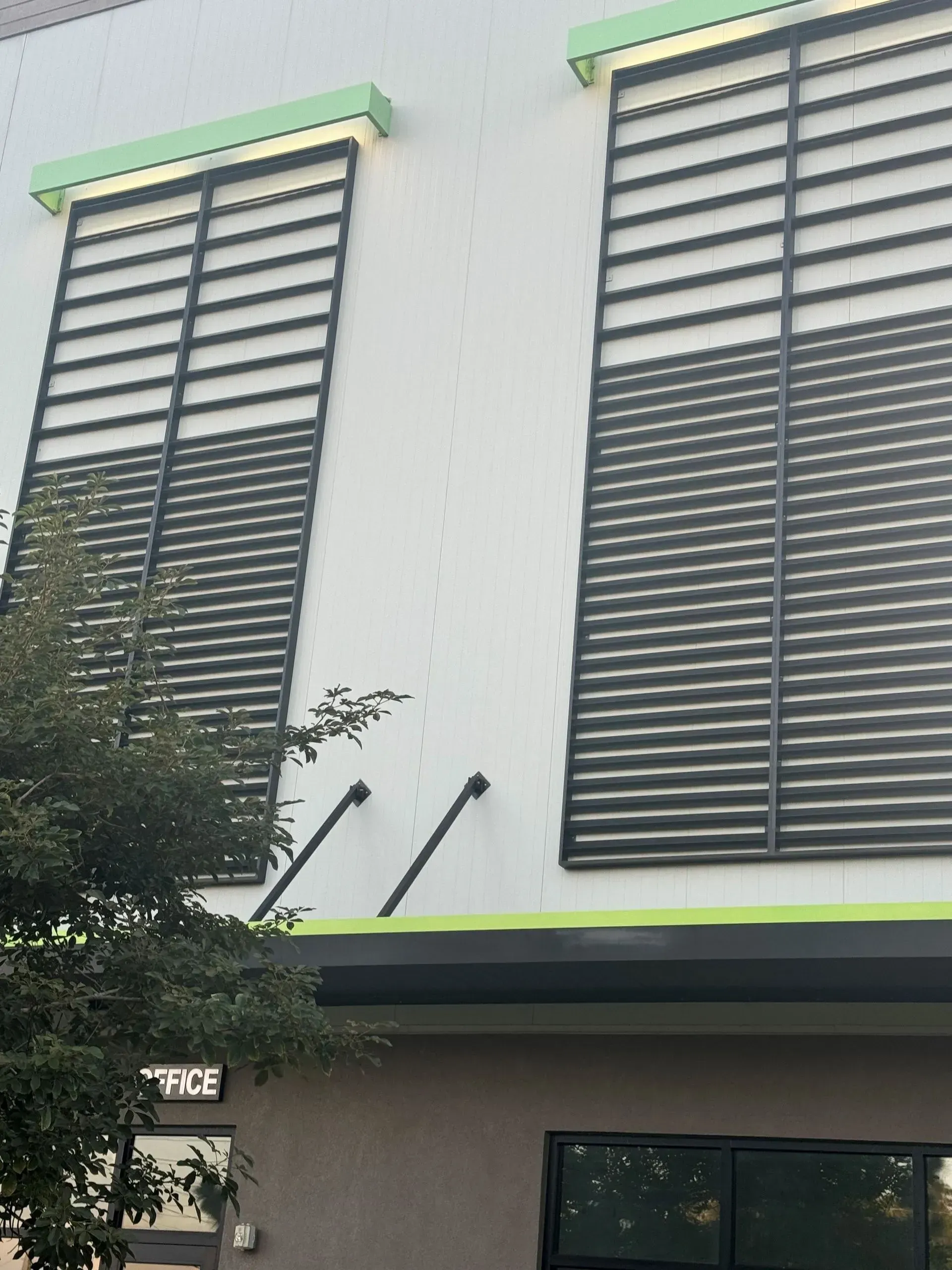 a building with a lot of windows and shutters on it