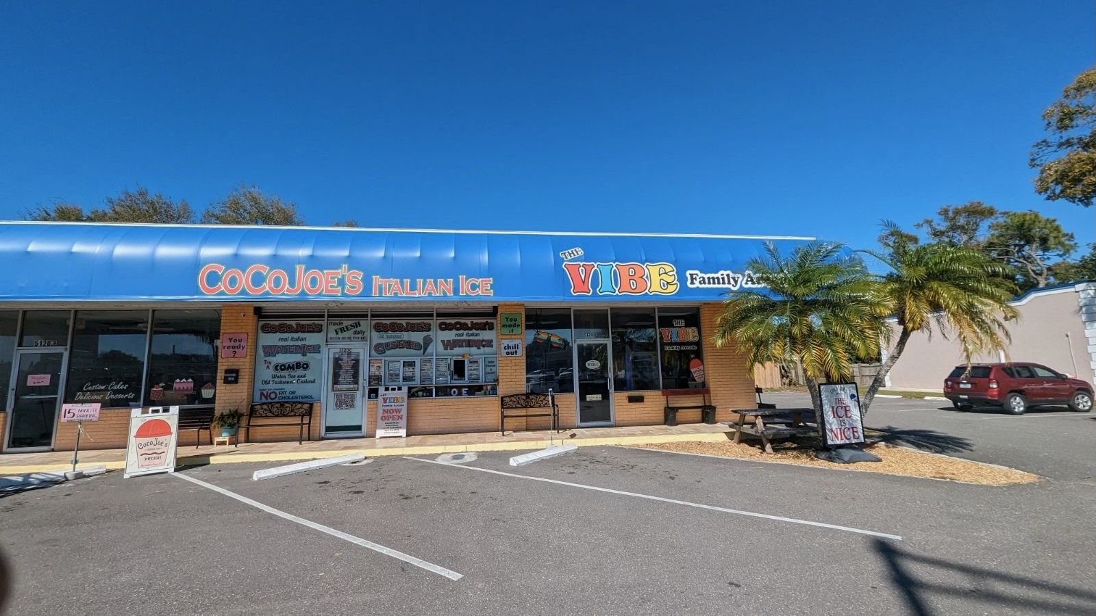 A store front with a blue awning that says coca cola on it