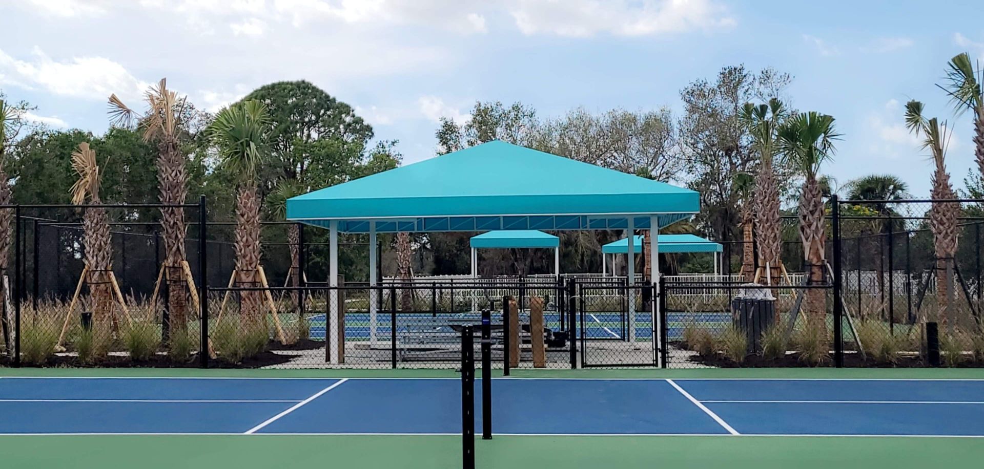 A tennis court with a blue canopy over it