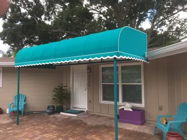 a house with a blue awning over the front door