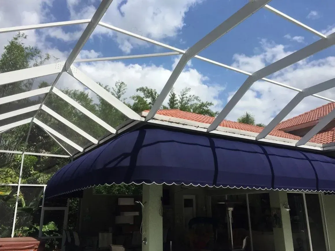 a house with a blue awning and a clear roof