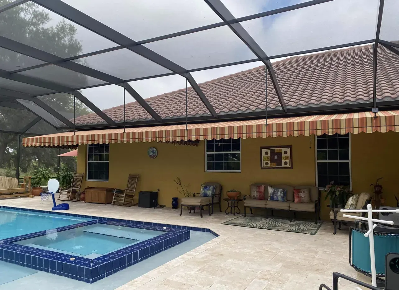 there is a swimming pool in the backyard of a house .