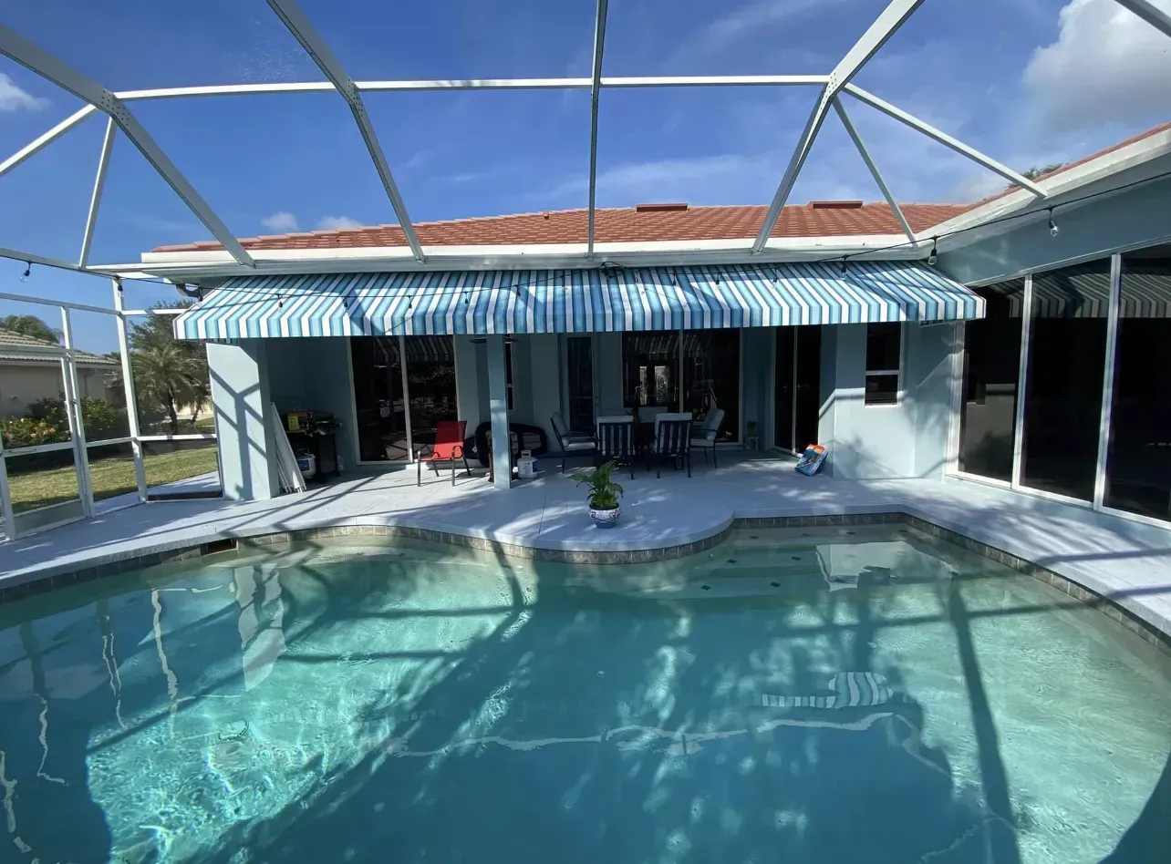 there is a swimming pool in the backyard of a house .