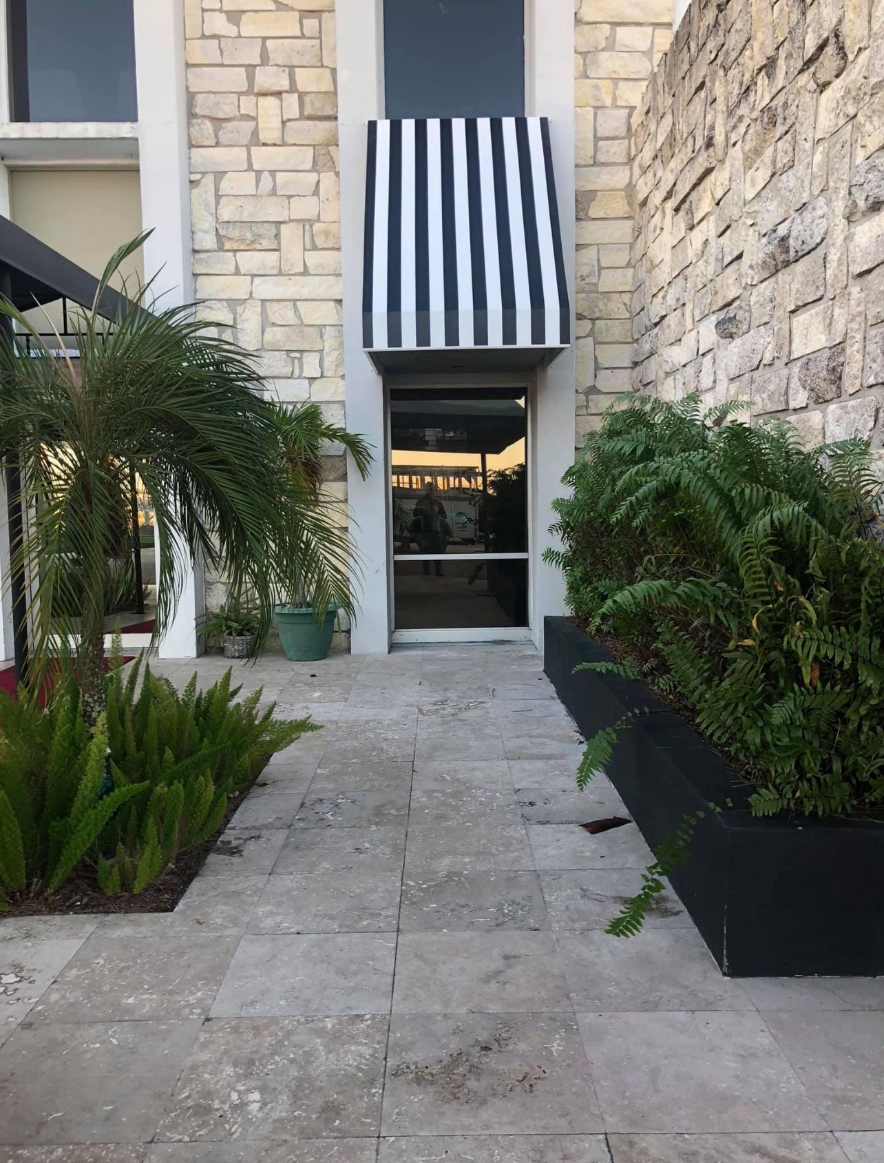 A black and white striped awning over a doorway
