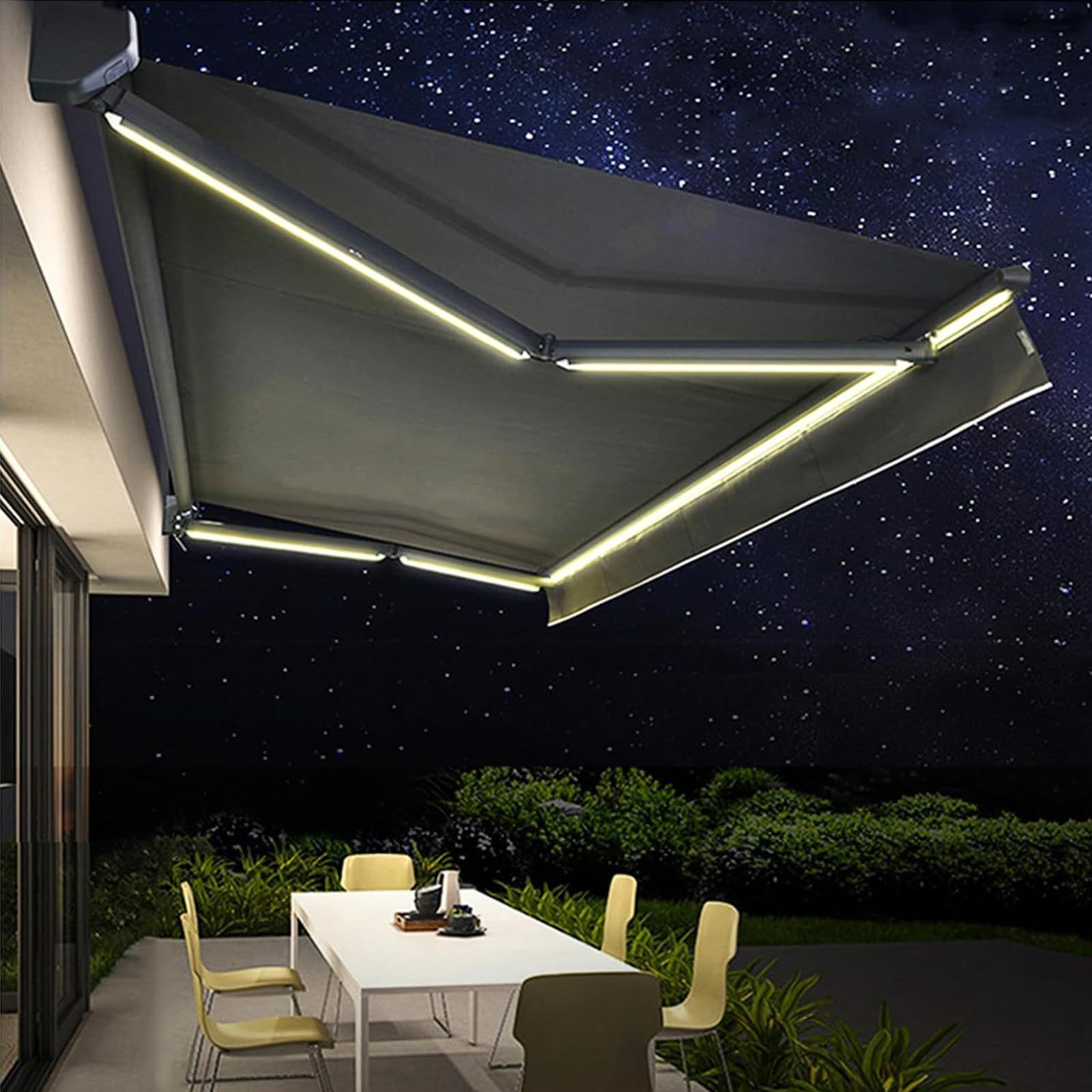Dark awning with integrated lights over a table and chairs on a patio at night.