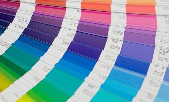 A close up of a rainbow of colors on a table.