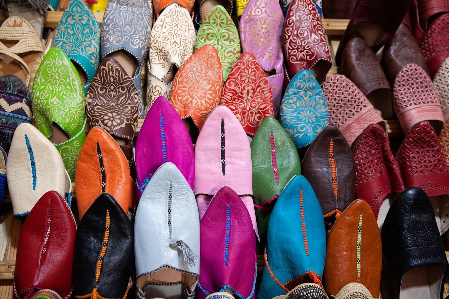 Colorful leather slippers on display.