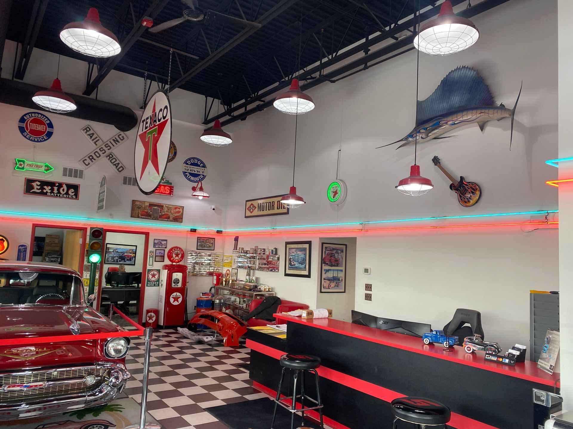 A diner with a checkered floor and a red car