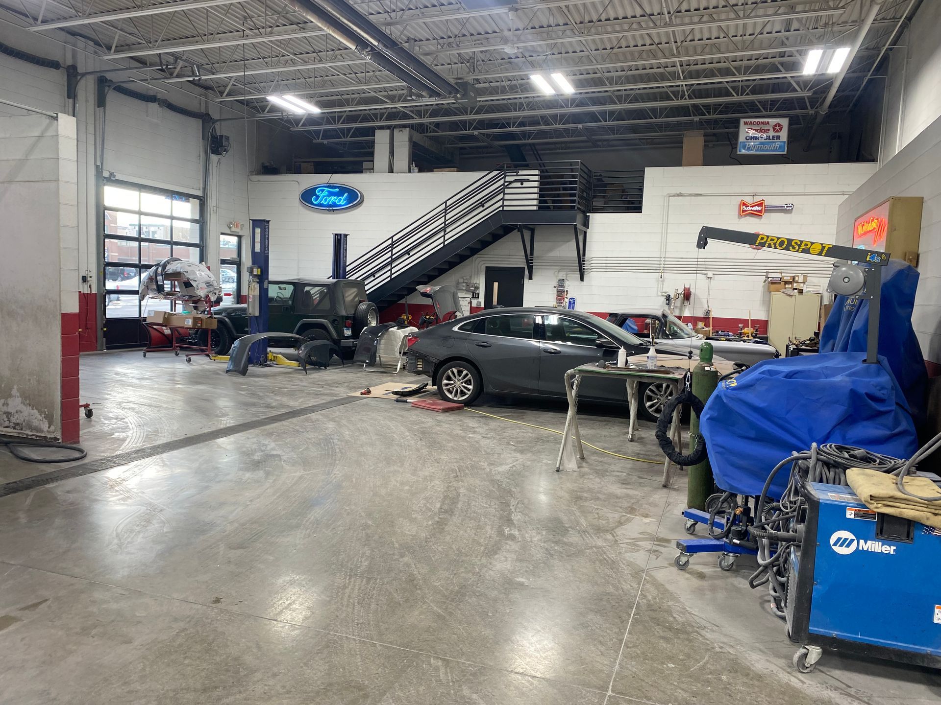 A car is being worked on in a garage.