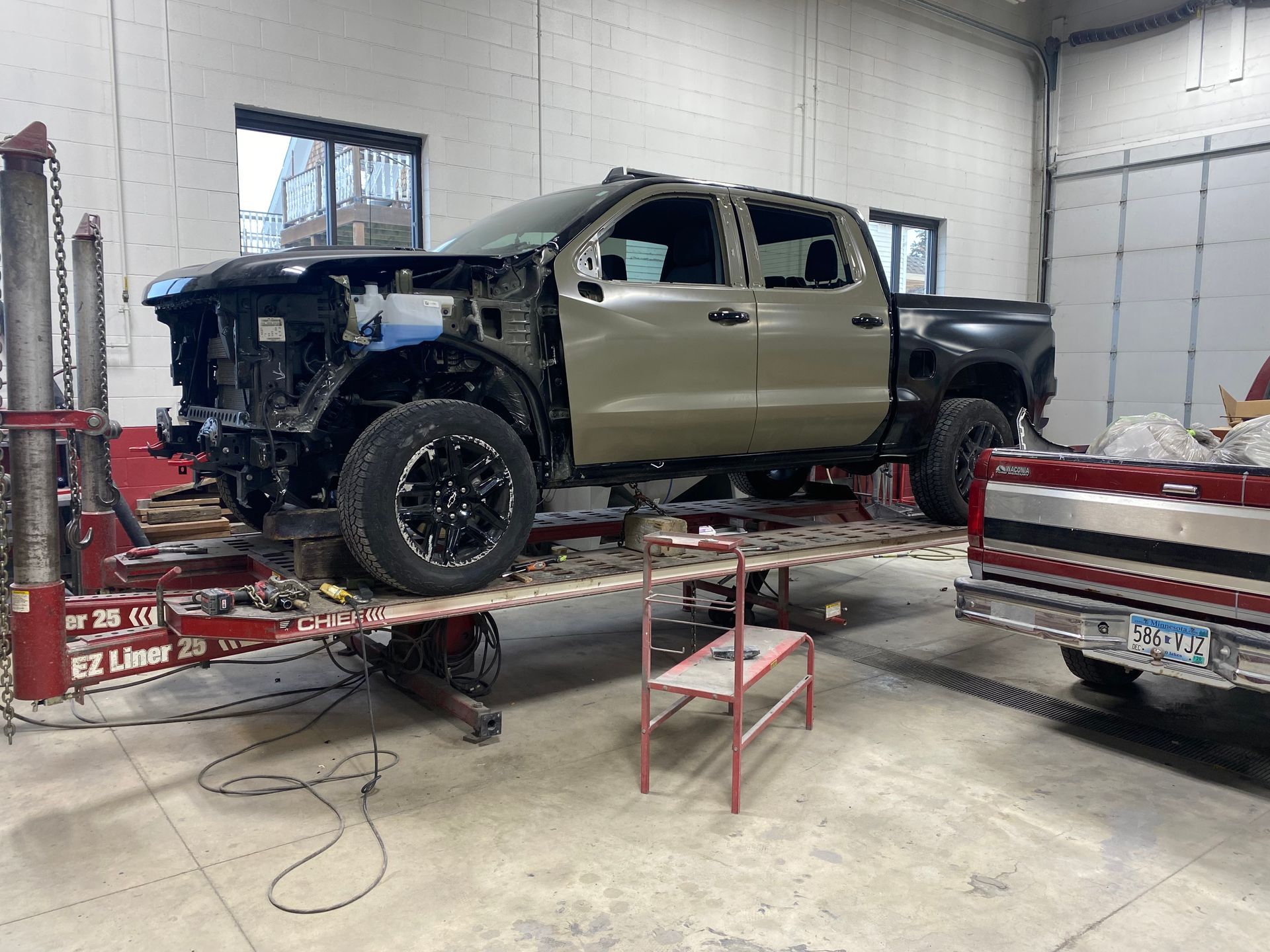 A truck is sitting on top of a table in a garage.