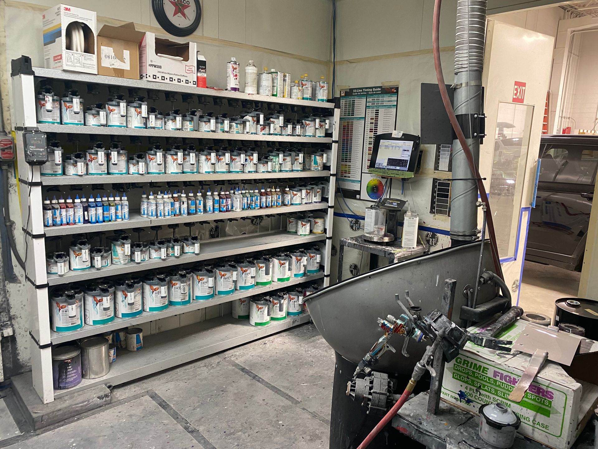 A room filled with shelves filled with lots of paint.