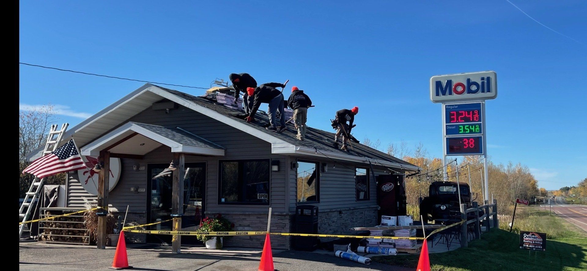A group of people are working on the roof of a building.