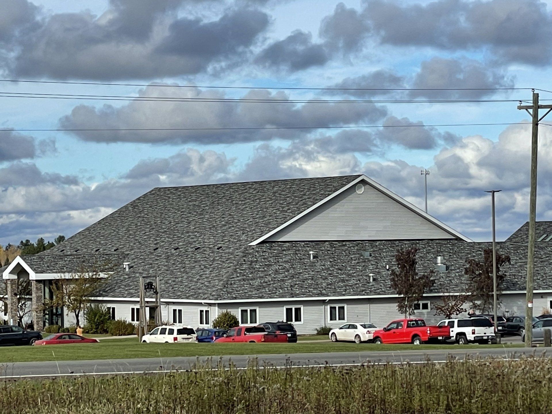 A large building with a lot of cars parked in front of it