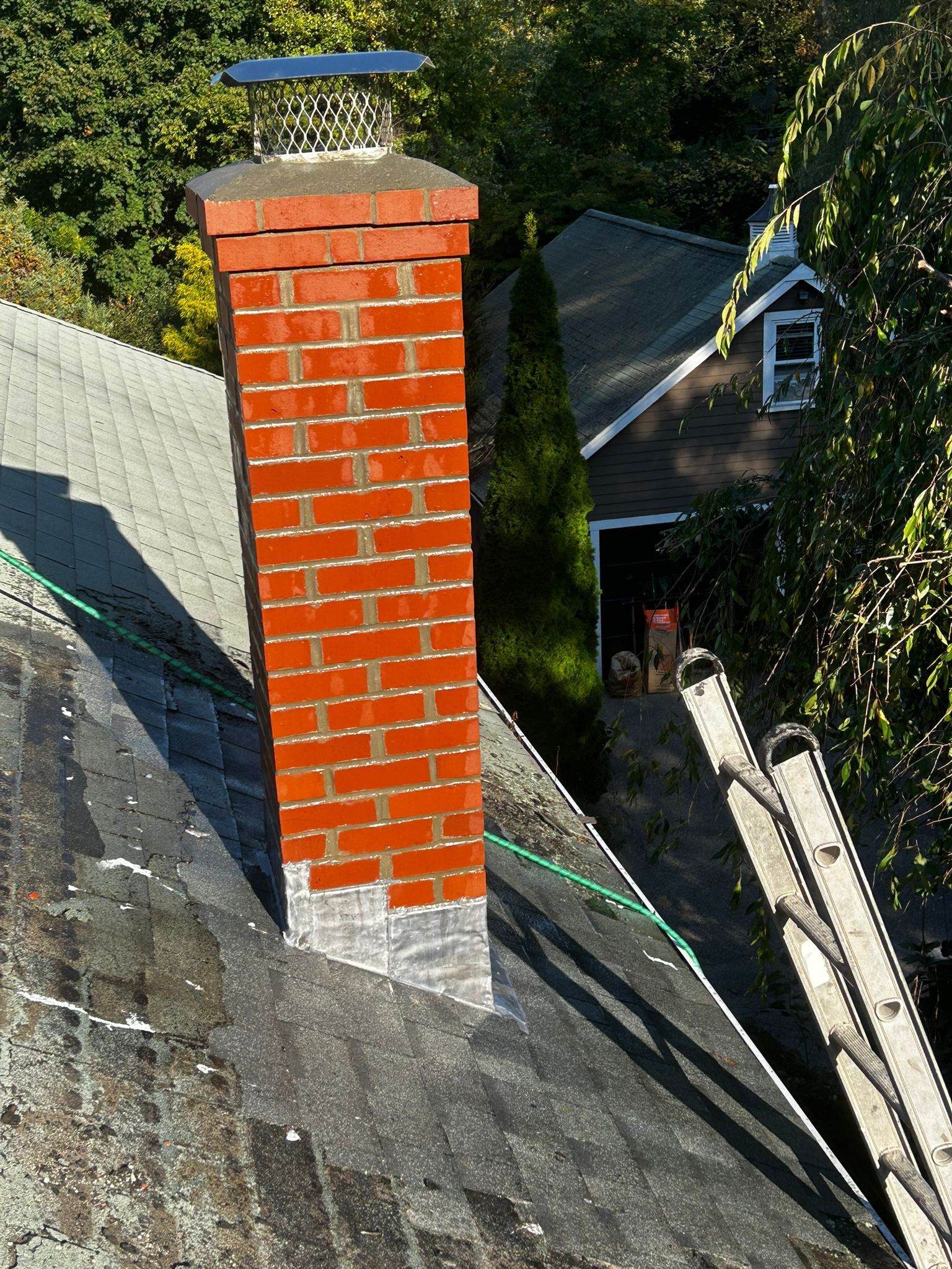 Brick chimney on a gray rooftop