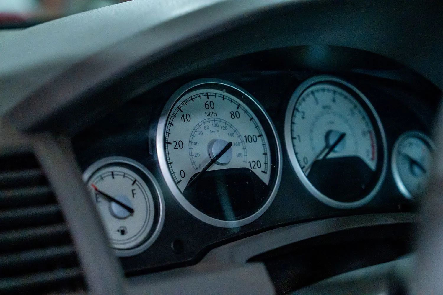 Dashboard of a vehicle with gauges displaying speed, fuel, and other information.
