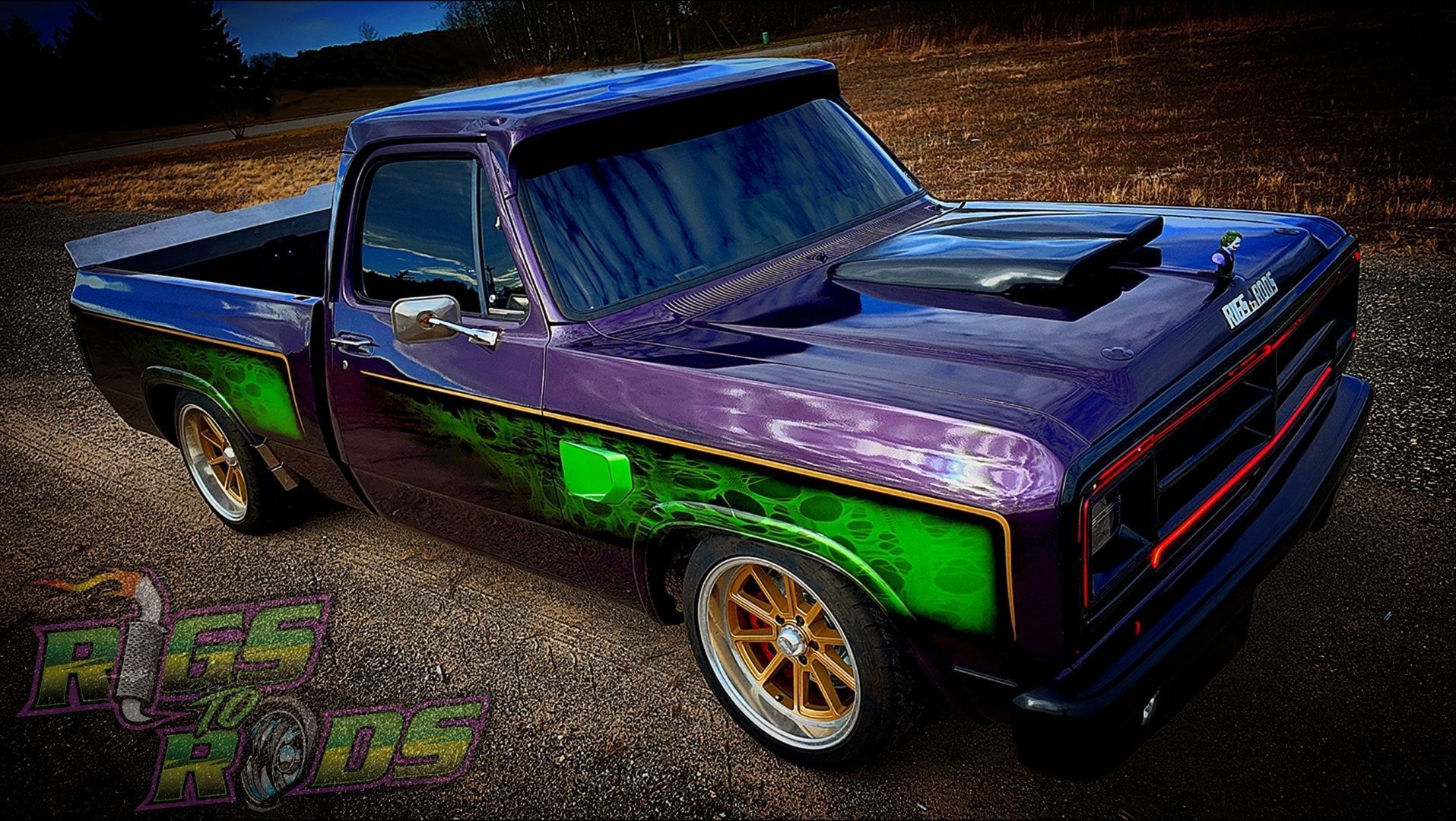 Purple and green custom pickup truck with gold wheels.