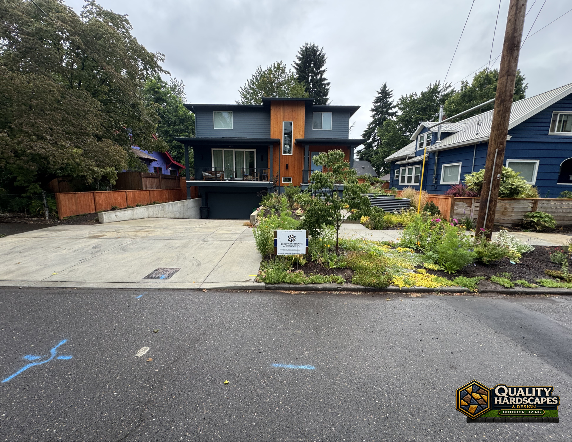 Modern two-story house with driveway, front garden, and street view in a residential neighborhood