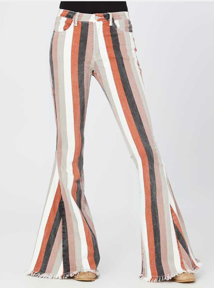 A woman is wearing a pair of striped flared pants.