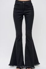 A woman is wearing a pair of black flared jeans.
