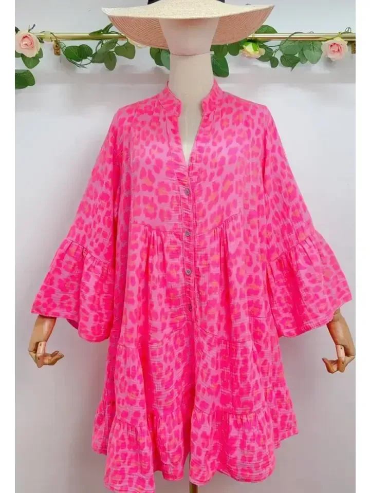 A mannequin wearing a pink leopard print dress and a hat