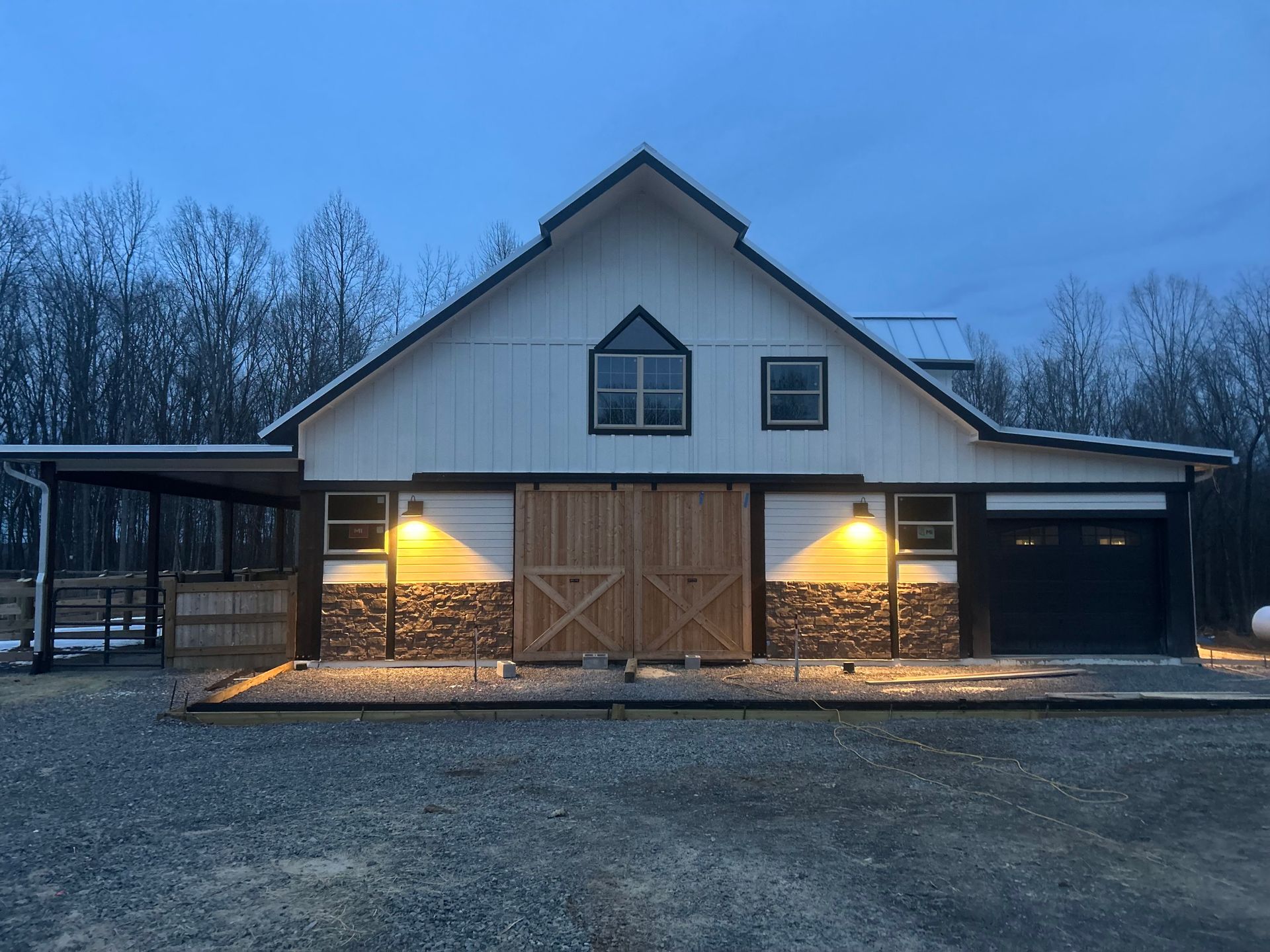 A large white barn with a sliding barn door