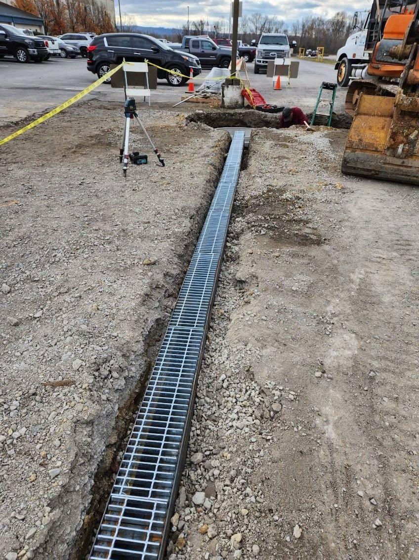 A drain is being installed in a parking lot.