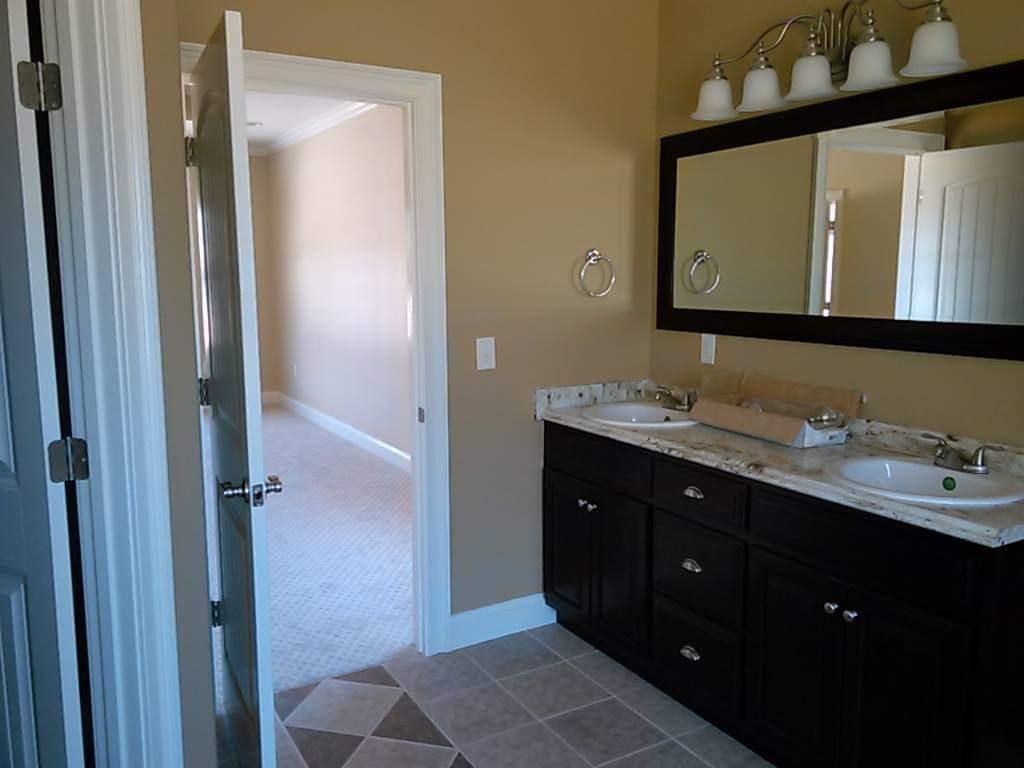 A bathroom with two sinks and a large mirror