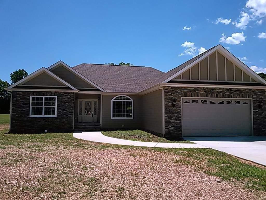 A house with a garage and a brick facade
