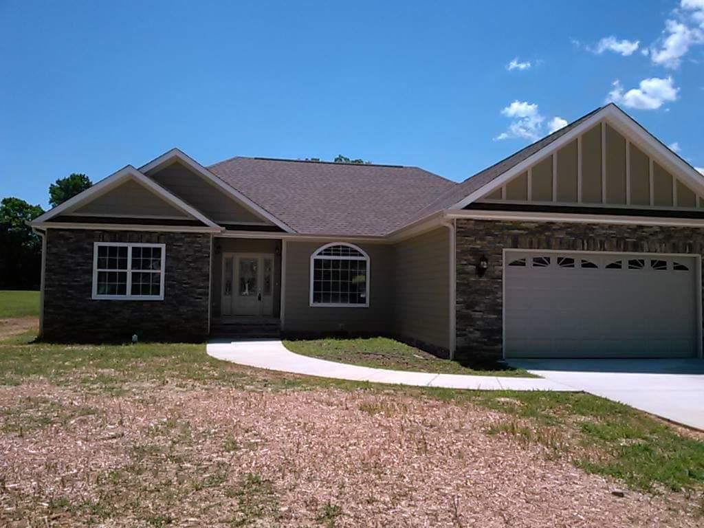 A house with a garage and a walkway in front of it