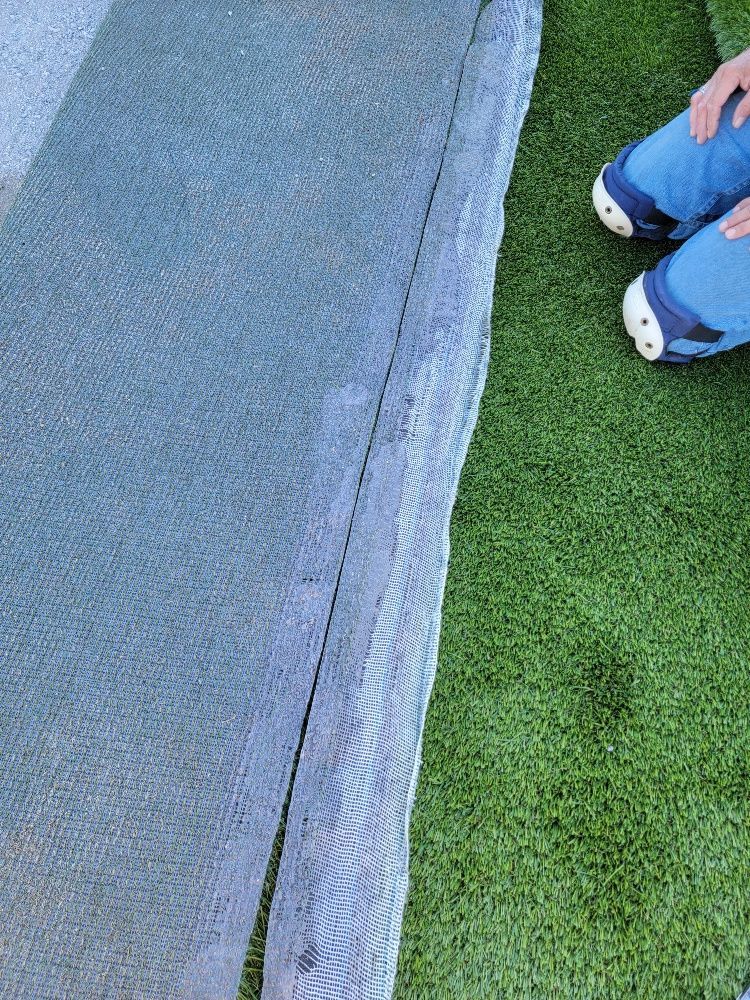 Green turf and a man's legs