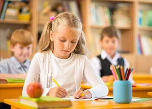 children writing in the classroom