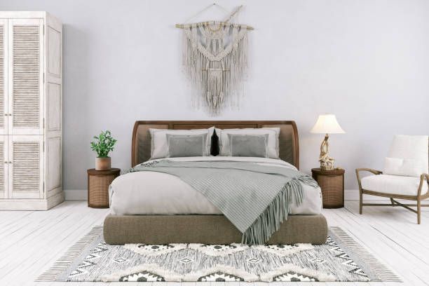 Boho bedroom: bed with textured headboard, macrame wall hanging, chair, neutral tones.