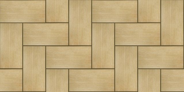 Wooden parquet flooring pattern. Light brown rectangular tiles arranged in a herringbone pattern.
