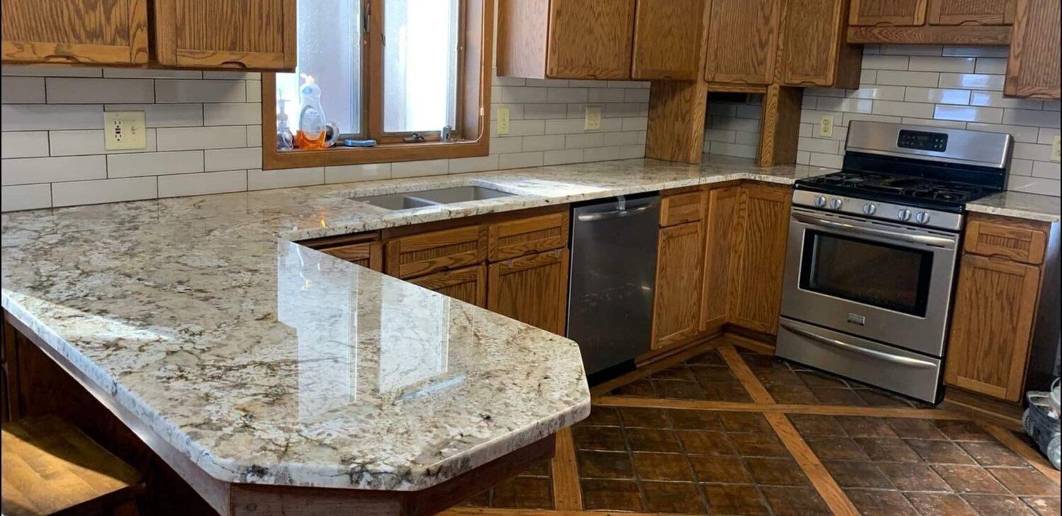 Kitchen with granite countertops, stainless steel appliances, and wood cabinets.