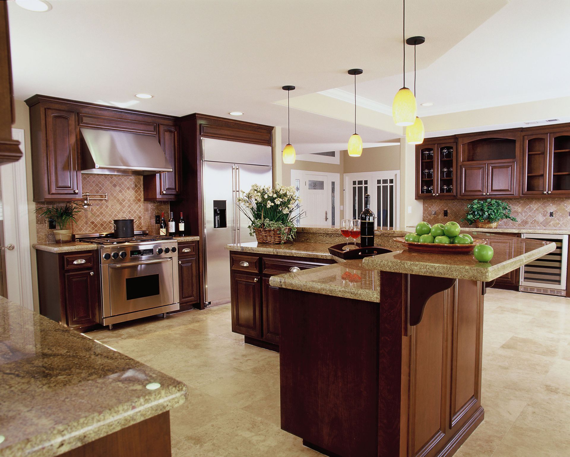 Elegant kitchen with dark wood cabinets, stainless steel appliances, and granite countertops.