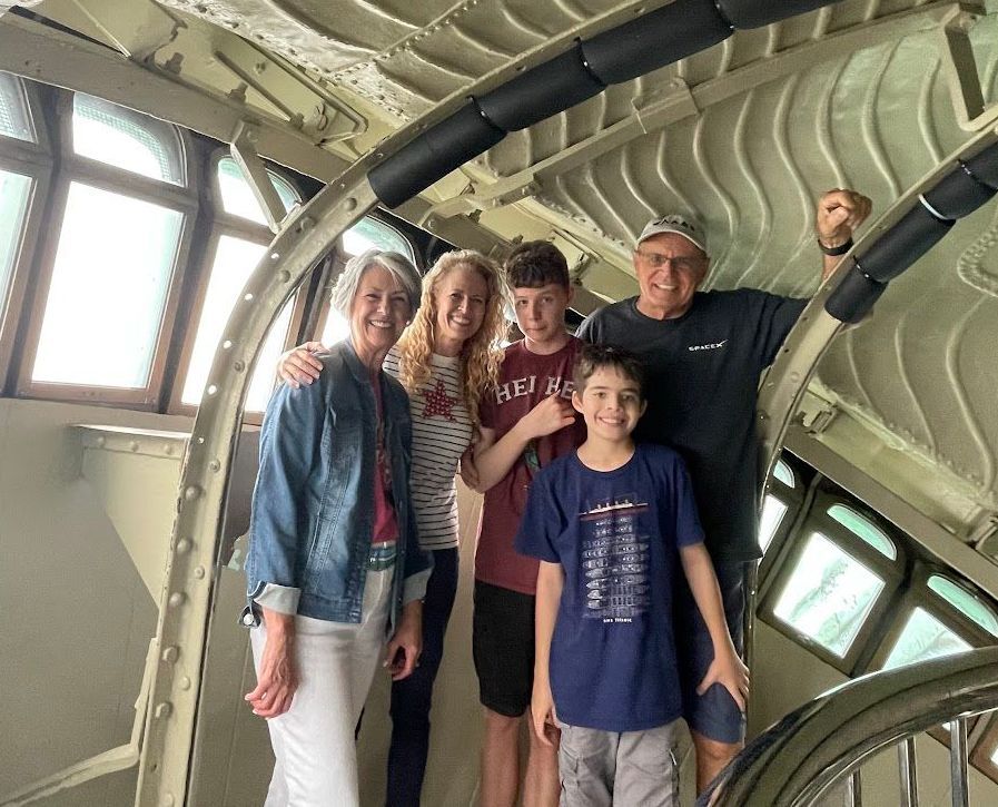 A family is posing for a picture in the statue of liberty.