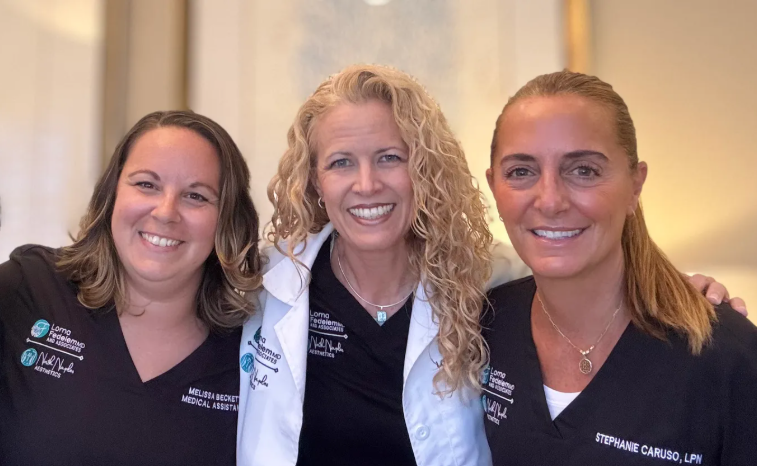 A group of four women are posing for a picture together.