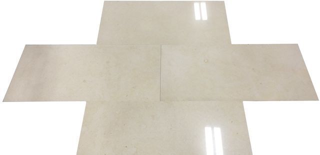 Cream-colored tiled floor in a cross-like shape with glossy reflections.