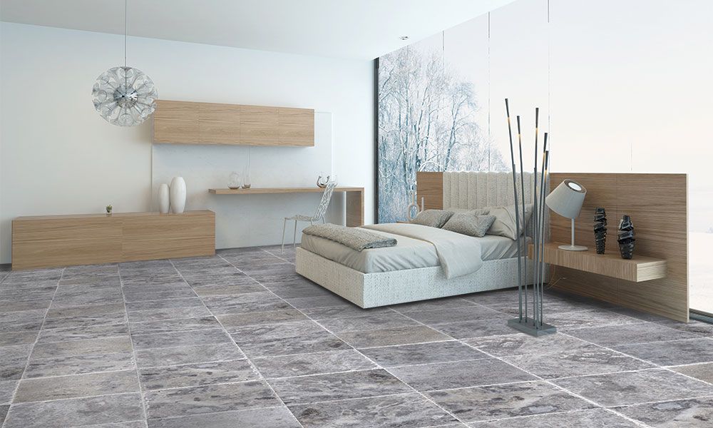 Modern minimalist bedroom with gray tile floor, wood accents, and a white bed beside a glass partition