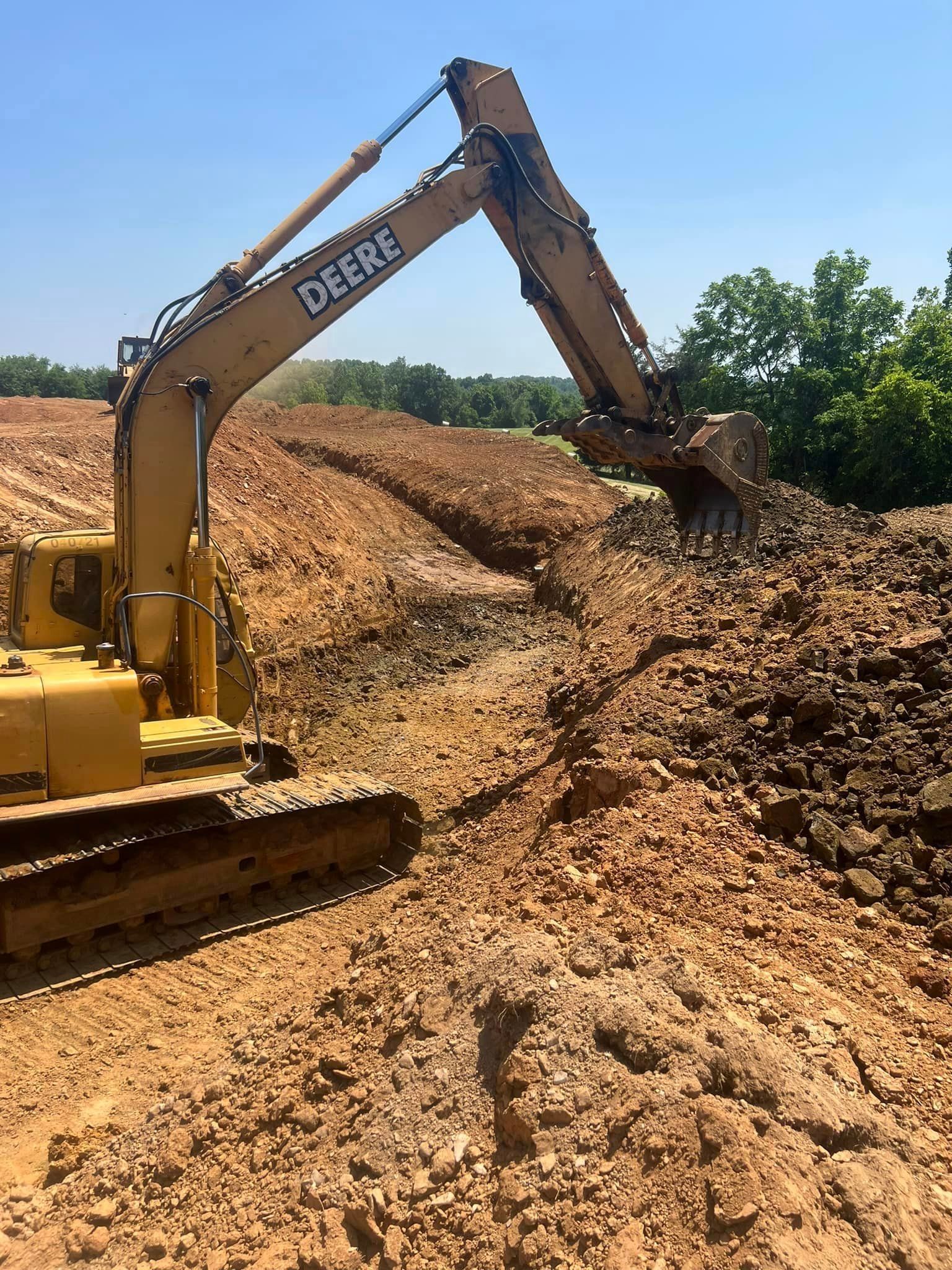 Yellow excavator digging in brown dirt, sunny day.