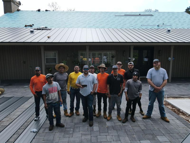 Group of construction workers standing in front of a building.