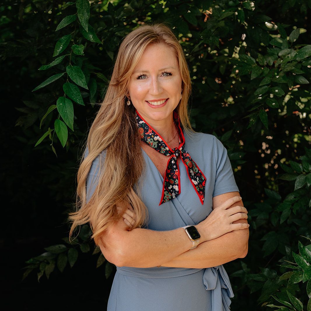 Mara Davidson in a black jacket and black shirt is smiling for the camera.