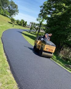 A man is riding a roller on a road.