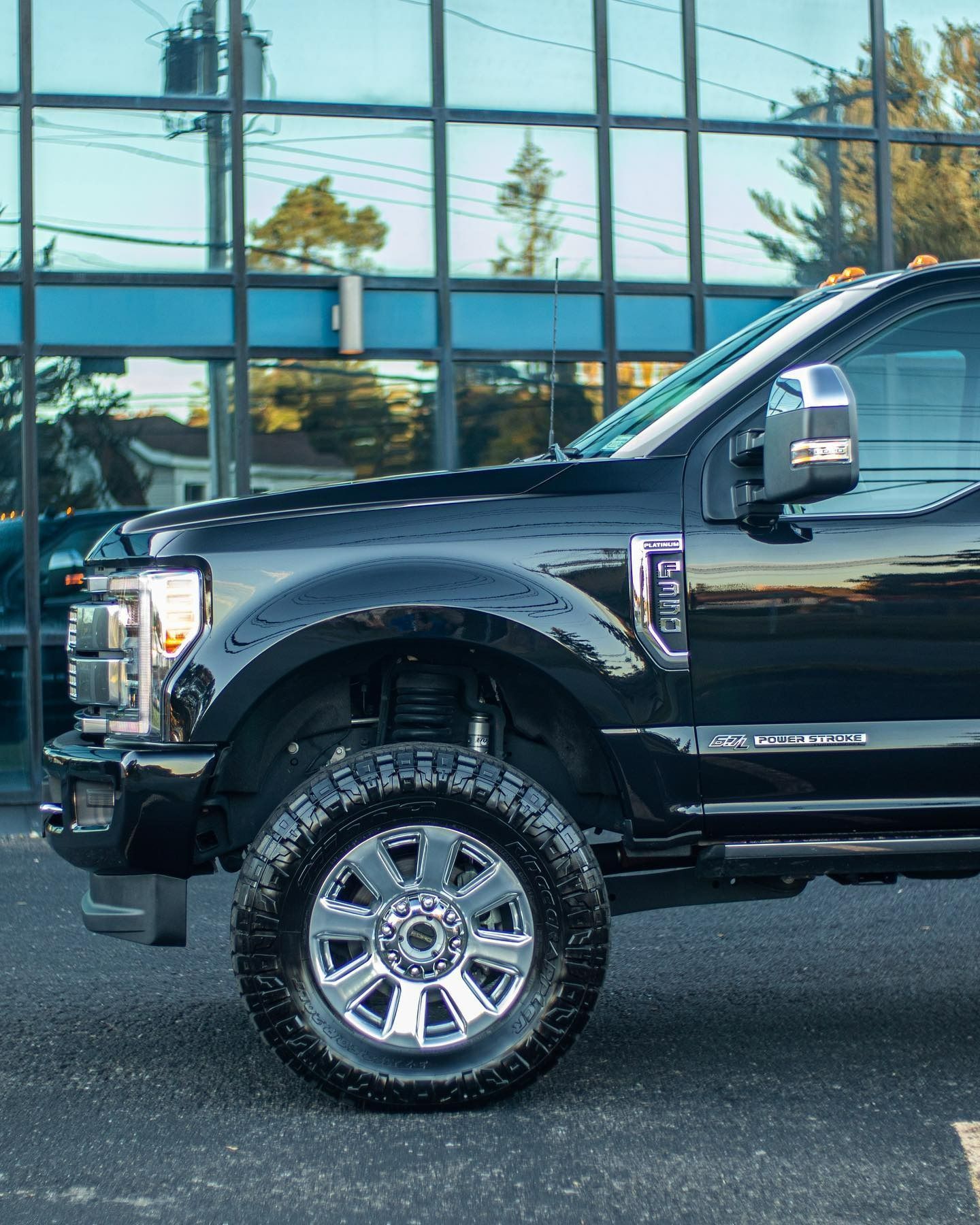 a black truck is parked in front of a building