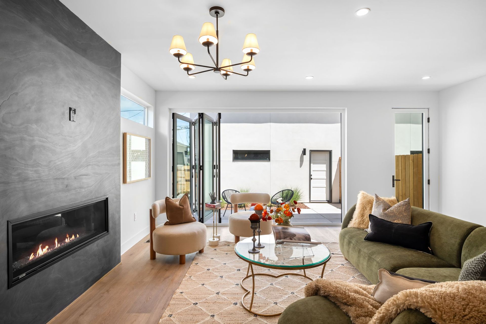Living room with fireplace, green sofa, and outdoor access.