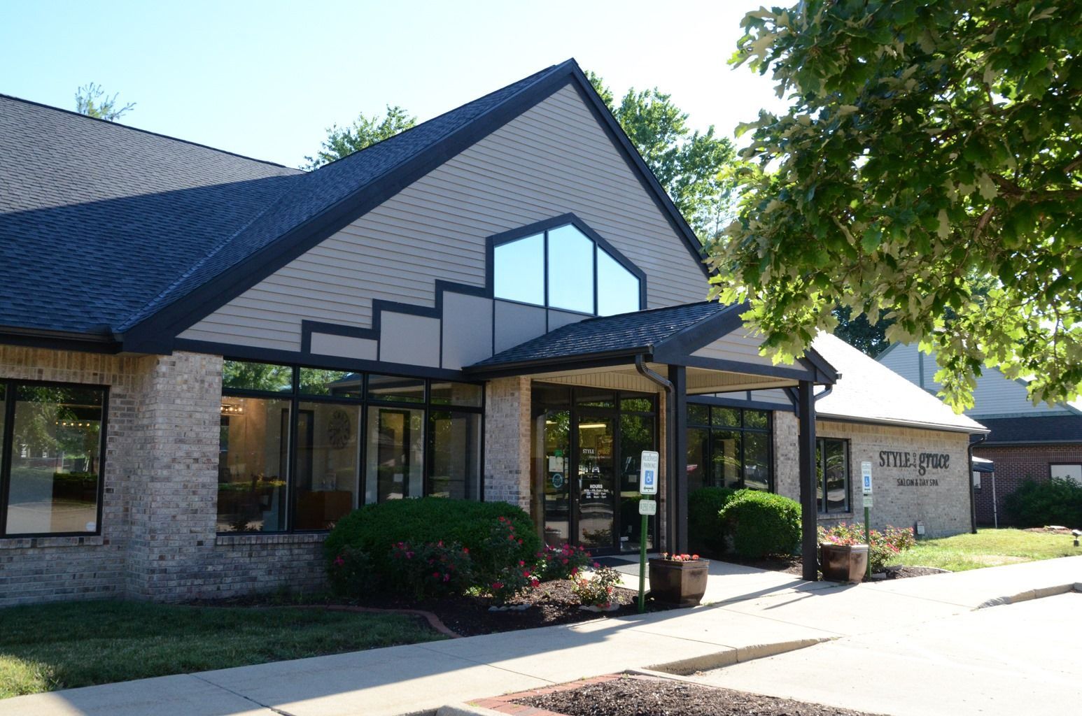 Salon interior with black styling chairs on mats, mirrors, and product shelves.