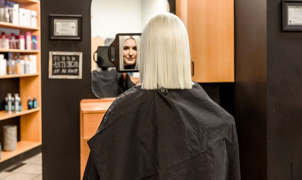 Blond, auburn, brown, and black hair strands, side-by-side, arranged in wavy lines.