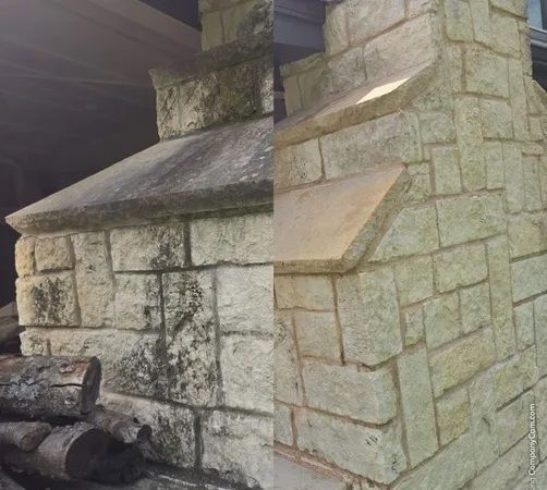 A side-by-side comparison of a stone fireplace, showing a dirty, dark-stained section next to a cleaned, light-colored one.