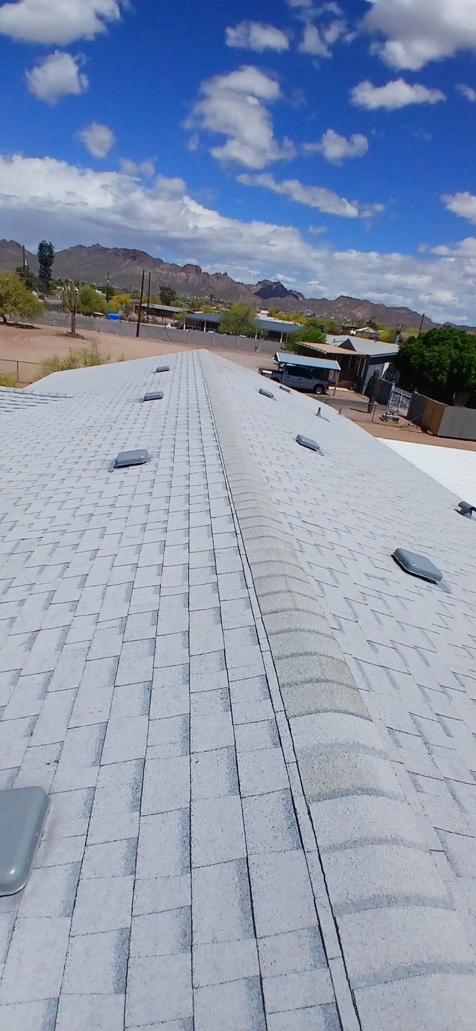 A white roof with a blue sky and clouds in the background