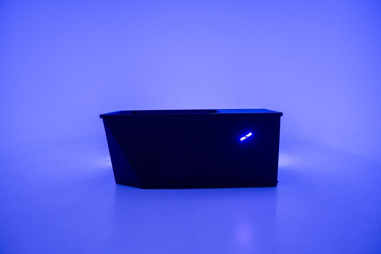 Dark box with a blue light on a blue surface.